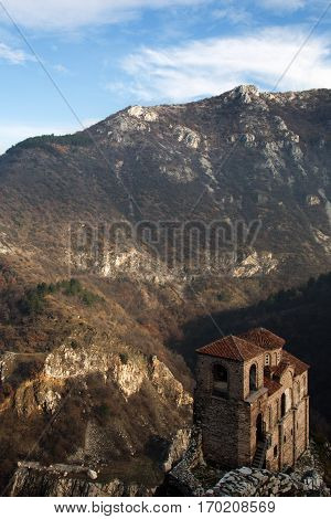 Ortodox church, the only reconstructed part of ancient fortress stands over the misty valley in Eastern Europe