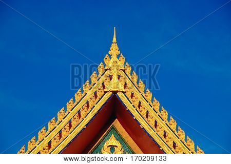 Gold Color Roof Of Buddhist Temple With Blue Sky Background.