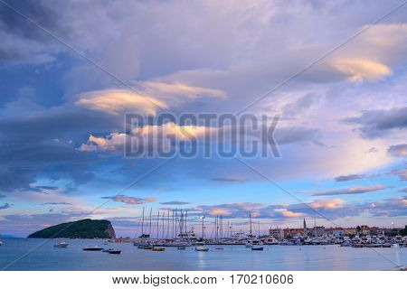 Panoramic View of Old Budva Town, Famous Island of Sveti Nikola and the Dock with Lot of Boats in Budva. Montenegro, Balkans, Adriatic sea, Europe.