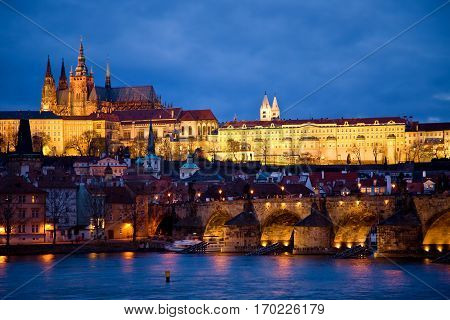 castle and st. charles bridge overlooking the vitava river in prague, czech republic.