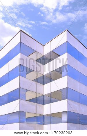 Modern architecture. Office building facade with some reflections on glass and concrete. Symmetry background and empty copy space for Editor's text.