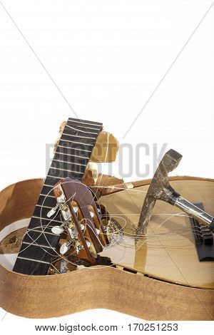An acoustic guitar that has been smashed with a hammer by its frustrated guitarist owner. No more scales practice.