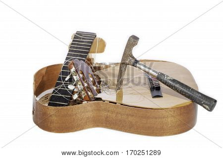 Demolished classical acoustic guitar. Guitar smashed by a hammer.