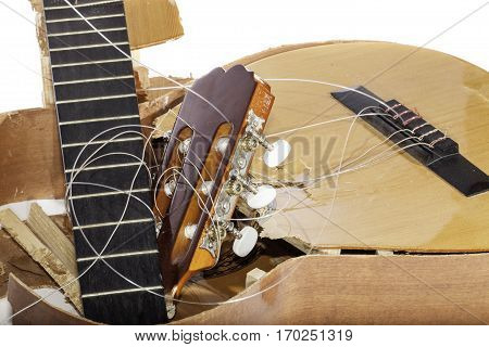 An acoustic guitar that has been broken into bits and pieces by its frustrated musician owner. Not musical after all.