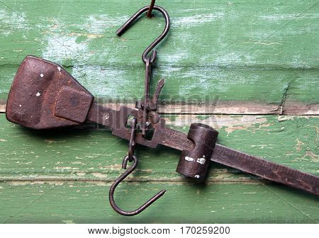 Vintage steelyard on a wooden background closeup