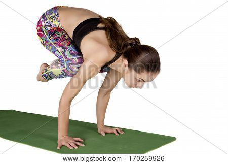 young beautiful girl in yoga pose isolated on white background in studio. Standing Bakasana. Handstand