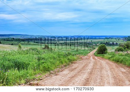 Dirt road in the village at summer