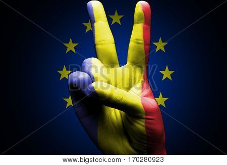 v sign hand cover with romanian flag over the european union flag black