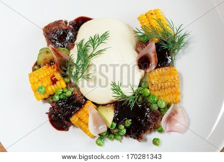 Pulled pork with grilled vegetables and potato mash shot from above, close-up