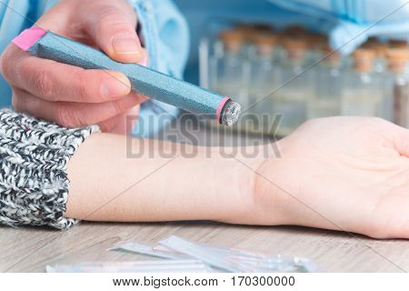Alternative medicine therapist doing moxa treatment on her client