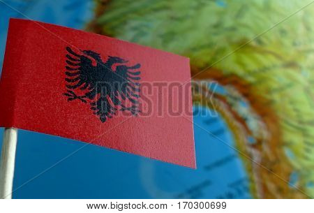 Albanian Flag With A Globe Map As A Background