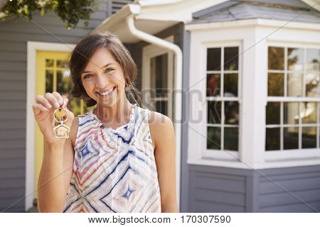 Woman With Keys Standing Outside New Home