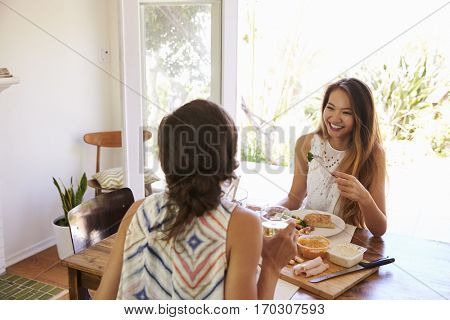 Two Female Friends Enjoying Meal At Home Together