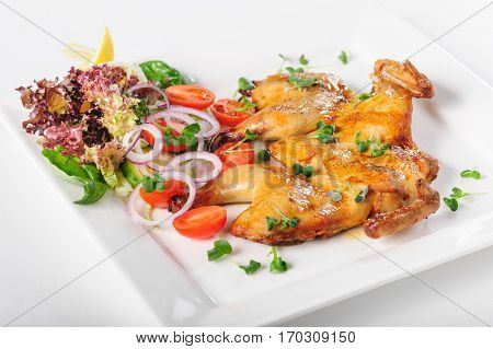 Chicken Tabaka with svegetable salad. Georgian or Caucasian cuisine.