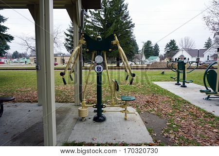 MANCELONA, MICHIGAN / UNITED STATES - NOVEMBER 27, 2016: One may exercise outdoors using fitness equipment in the Railroad Park Fitness Zone, near downtown Mancelona.