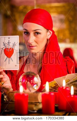 Fortuneteller with Tarot cards or esoteric Oracle, sees in the future 
