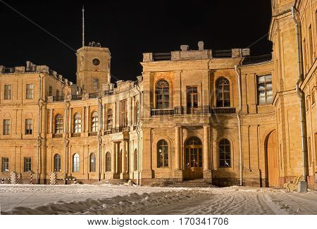 Gatchina Palace. Entrance to the right wing. Night Photography. At the clock tower is installed a flagpole for the imperial flag. Russia.
