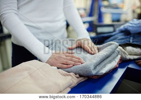 Working in dry-cleaning shop