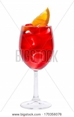 Wineglass with red fruit coctail decorated with lemon slice and ie close-up on the white background