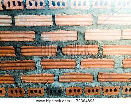 Background of brick wall texture  of industrial bricklayer installing bricks on construction site