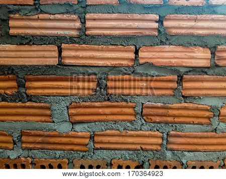 Background of brick wall texture  of industrial bricklayer installing bricks on construction site