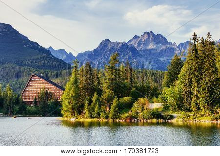 The sunrise over a lake in the park High Tatras. Shtrbske Pleso, Slovakia, Europe.