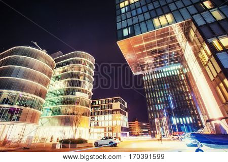 Night city osvitchene neon. Fantastic view of buildings in Germany