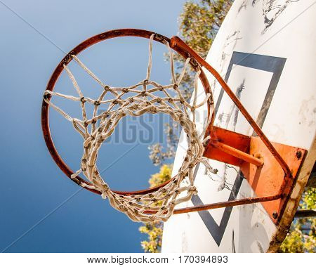 Looking up through Basket ball hoop to the sky