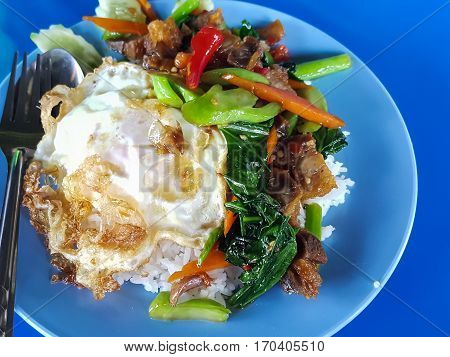 Close-upThai food:fried kale with crispy pork egg