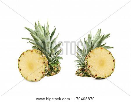 Upper half of a pineapple fruit next to a cross-section slice, composition isolated over the white background, set of two different foreshortenings