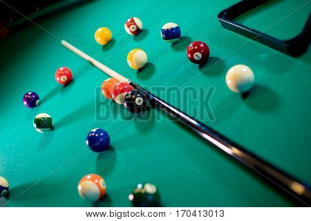 billiard table with billiard balls, cue and billiard triangle