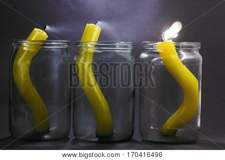 extinguished candles. Three candles in a glass jar