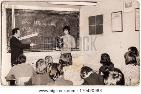 PIESZYCE, POLAND, CIRCA 1970's: Vintage photo of a teacher and pupils during a math lesson