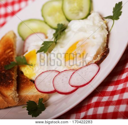 fried eggs and toast - excellent breakfast on white plate