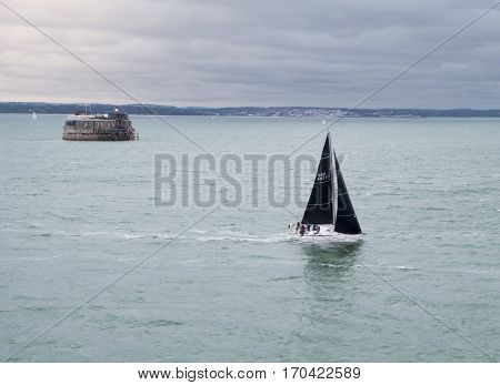 Sailboat navigating through stormy northern cold waters
