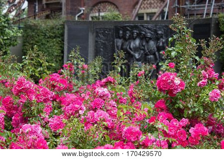 Kate Sheppard memorial and pink camellias in front of in in Christchurch New Zealand