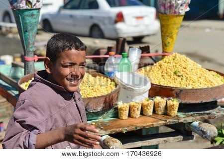 CAIRO, EGYPT - 02 APRIL 2016: The child street vendor sells chickpea snack in Cairo, Egypt. 