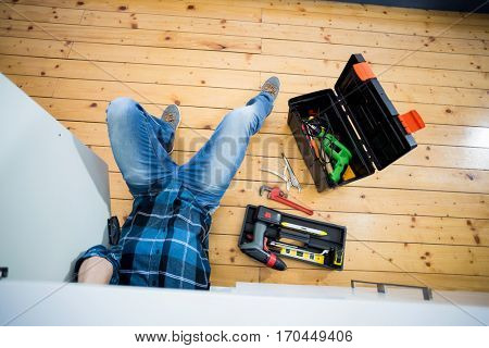 Man fixing kitchen sink in the kitchen