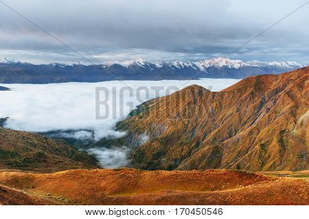 Snow-covered mountains in the mist. Autumn at Koruldi Lake. Europe, Georgia, Upper Svaneti, near mt. Ushba.