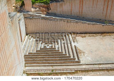 Tiny maze made of stone blocks in old abandoned stone quarries Lithica Pedreres des Hostal, Menorca island, Spain.