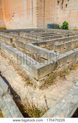 Tiny maze made of stone blocks in old abandoned stone quarries Lithica Pedreres des Hostal, Menorca island, Spain.