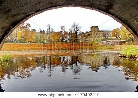 Beautiful romantic alley in a park with colorful trees and sunlight. autumn natural background. Gatchina