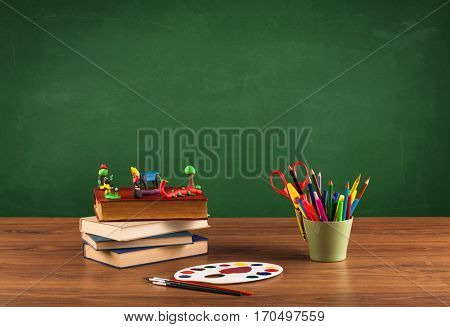Back to school concepty with clear blackboard background, desk, items
