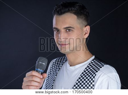Male Black-haired Pop Singer Performs Singing To Microphone