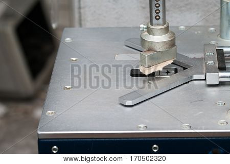 Craftsman working on frame in frame shop. Professional framer hand holding frame angle. Top view.