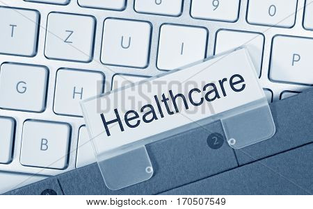 Healthcare - folder with text on computer keyboard