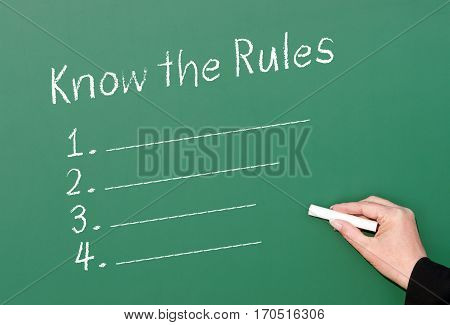 Know the Rules - female hand with chalk and checklist