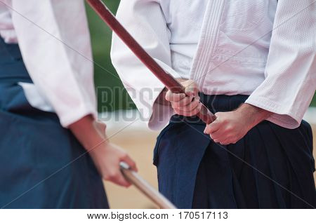 Aikido fighters with bokkens traditional Japanese wooden swords