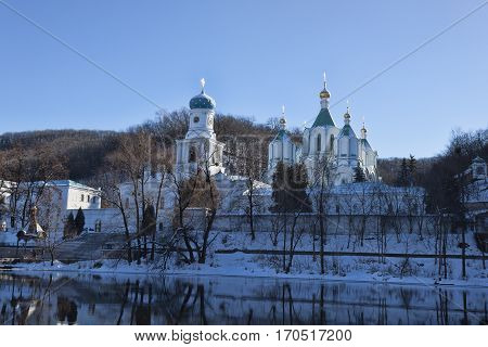 Churches of Sviatohirsk Lavra. Sunny day in January. On the waterfront