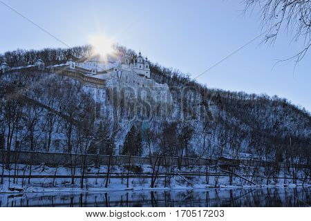 Churches of Sviatohirsk Lavra. Sunny day in January. On the waterfront
